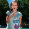 Girl enjoying Blue Raspberry gourmet kettle corn.