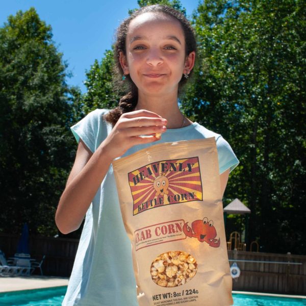 B07BJGL8FH.PT03 Crab Corn kettle corn Family Size bag, pool lifestyle view.